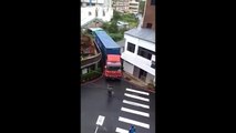 A skilled driver easily turns a truck in between two buildings - Amazing Driver Skills