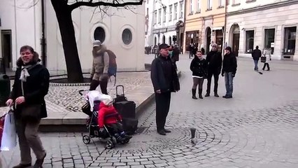 A street artist performs. What makes her daughter is amazing