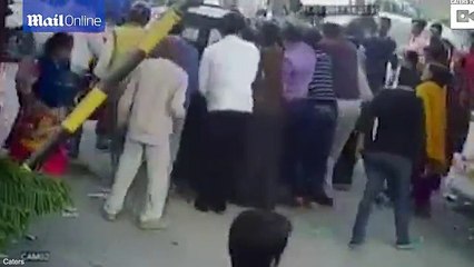 Indian woman sandwiched between two cars is caught on camera