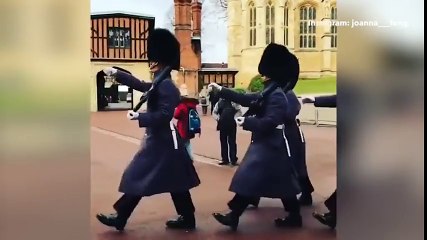 Cute moment boy in Guardsman uniform salutes soldiers