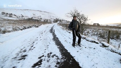 Man traverses road on skis in Northern Ireland following heavy snowfall