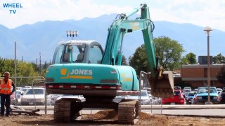 Blue Jones Excavator moving dirt next to a road, construction machine