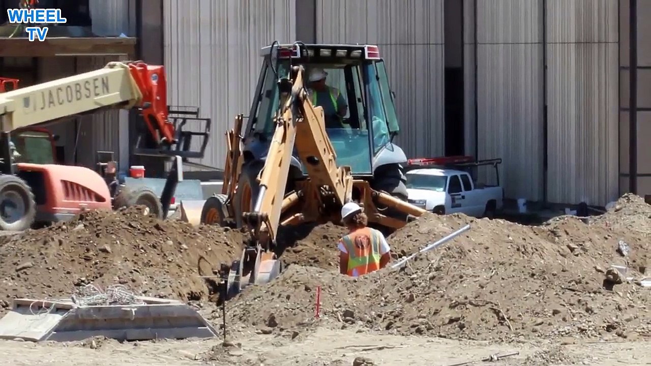 Case Backhoe digging with excavator arm in a trench, construction machine