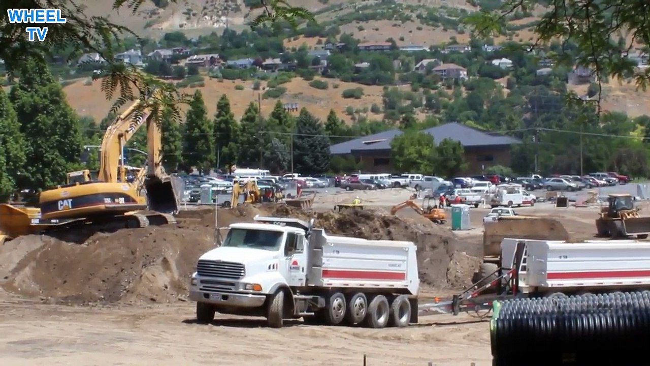 Big Construction Site excavators loader and dump trucks all working, construction machine