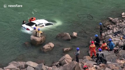 Firefighters and police officers rescue driver who crashed into river