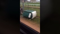 Lout pushes portaloo over with man inside in shocking video at racecourse