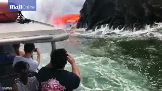 Spectacular moment volcano lava spews into sea yards from tourists