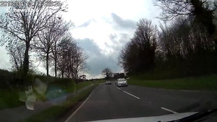 Motorist narrowly escapes hitting car on two wheels