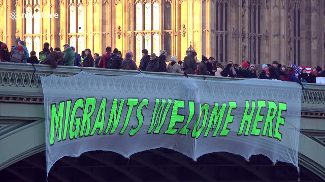 Anti-Trump protesters unfurl banners on Westminster Bridge, London