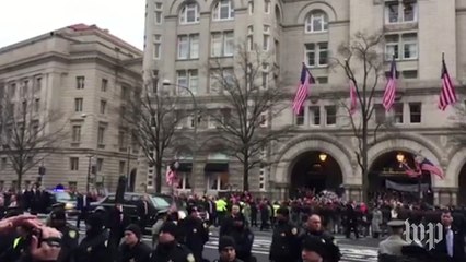 Protesters boo Trump motorcade along parade route