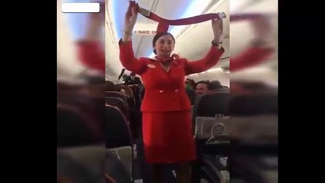 Football fans distracting the Air Hostess on flight during the safety announcement-ea4hDyprVvY