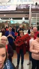 People praying At Dallas Airport during protest against Trump