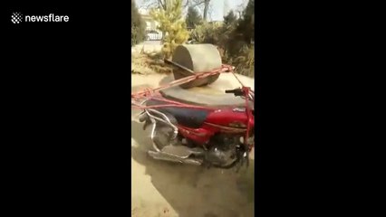 Creative woman mechanises ancient stone mill with motorcycle