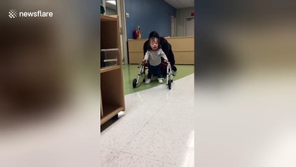 Baby with Down's syndrome learns to walk with special frame