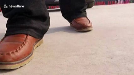 Kung-fu master pulls car with his ear