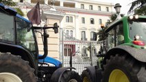 Greek farmers take the streets and block government building with tractors