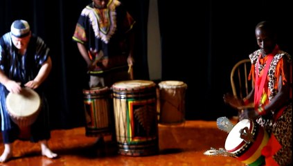 great west african men playing drums with europeans