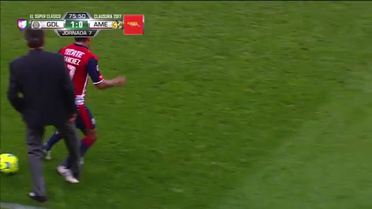 Club America's manager Ricardo La Volpe takes a step onto the pitch and tackles Chivas player!