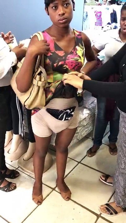 Shoplifter hiding clothes