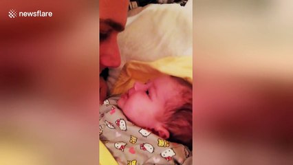 Cute baby tries to eat her daddy's nose
