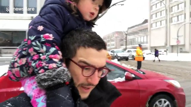 Father walks around Montreal with his daughter after two days of snow