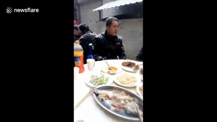 Villagers hold wedding banquet under snowfall