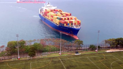 Container ship sails straight to shore by university football field