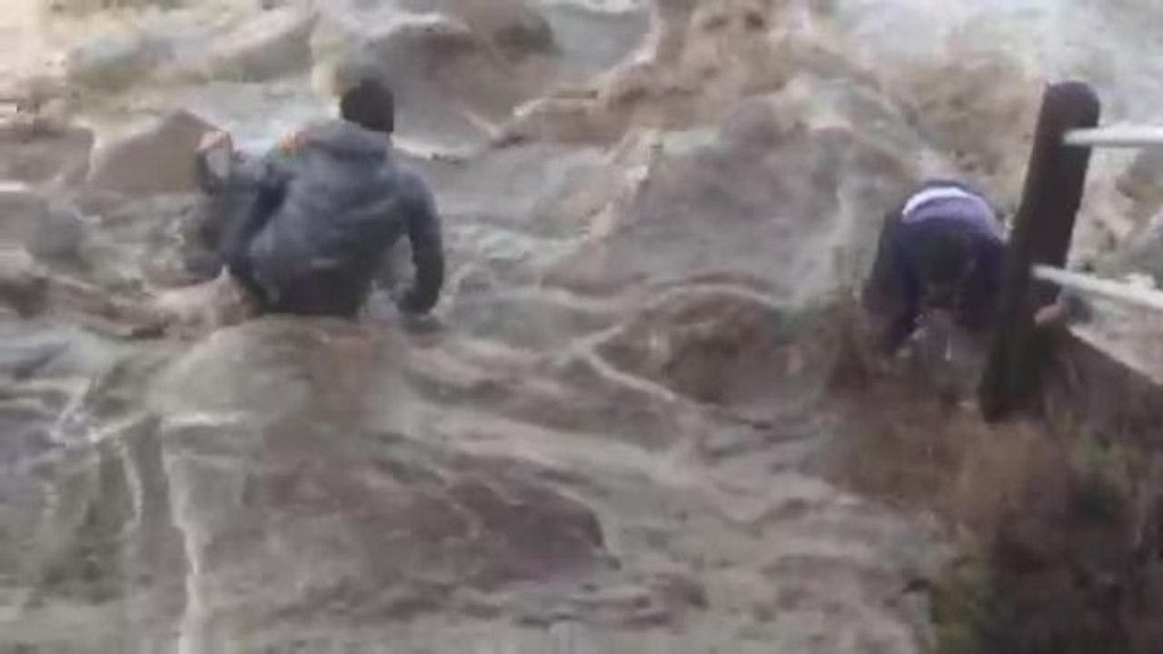 Men almost swept away by massive wave