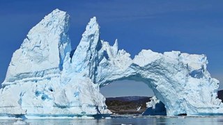 Tourists Watch An Iceberg Bridge Collapse In Greenland