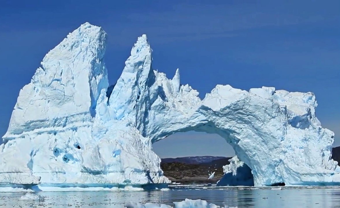 Tourists Watch An Iceberg Bridge Collapse In Greenland
