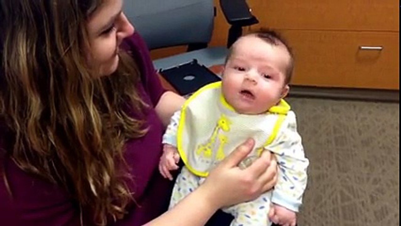 Baby hears his mom for the first time with hearing aids.