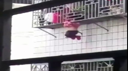 Two Men Saved a Little Girl Hanging From Fourth Storey Window of a ResidentialBbuilding Tuesday in the City of Meizhou,