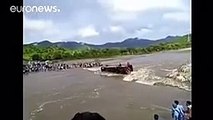 Passengers escape through windows as bus overturns in swollen river, Peru - YouTube