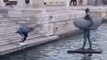 Tourist Takes Leap to Reach Waterfront Statue in Alicante