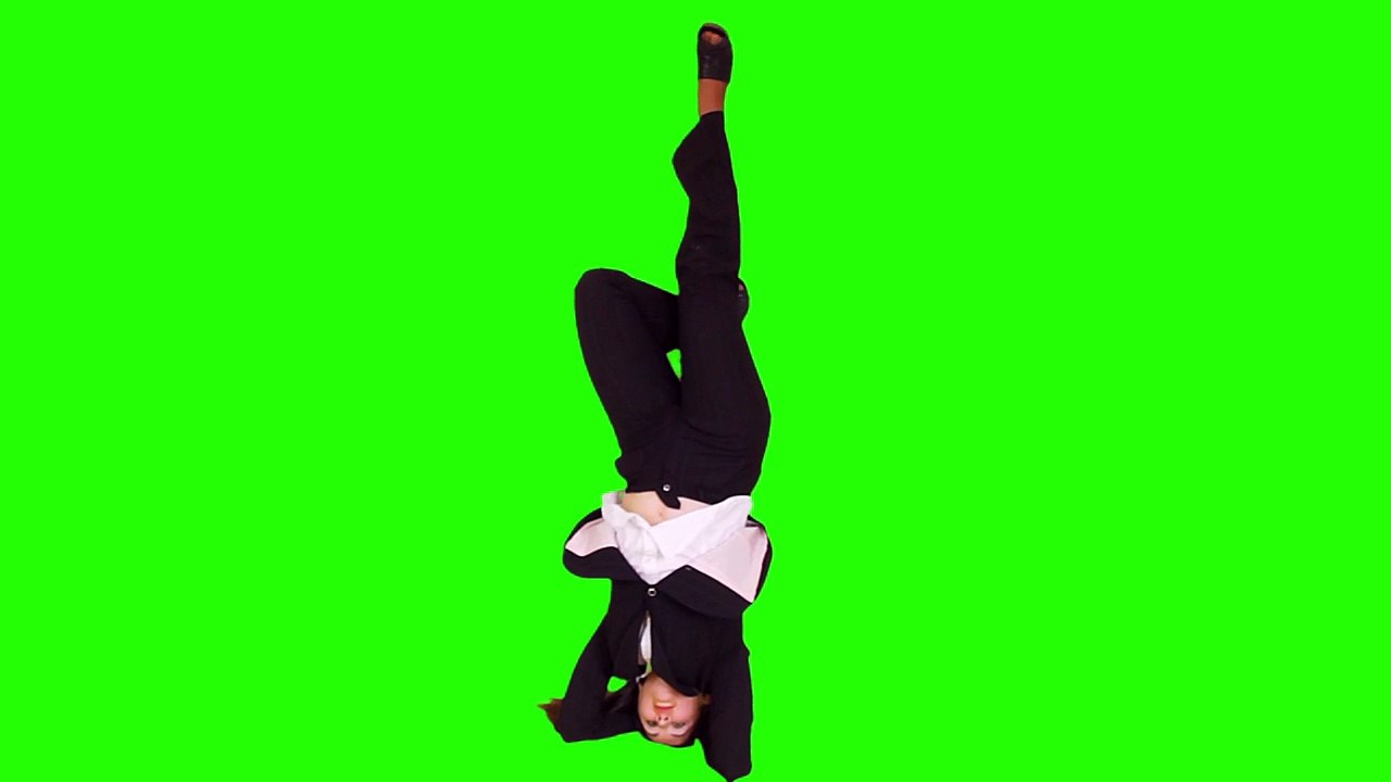 Business woman talks on the phone while doing headstand.