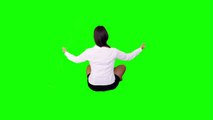 Businesswoman meditating on green screen.