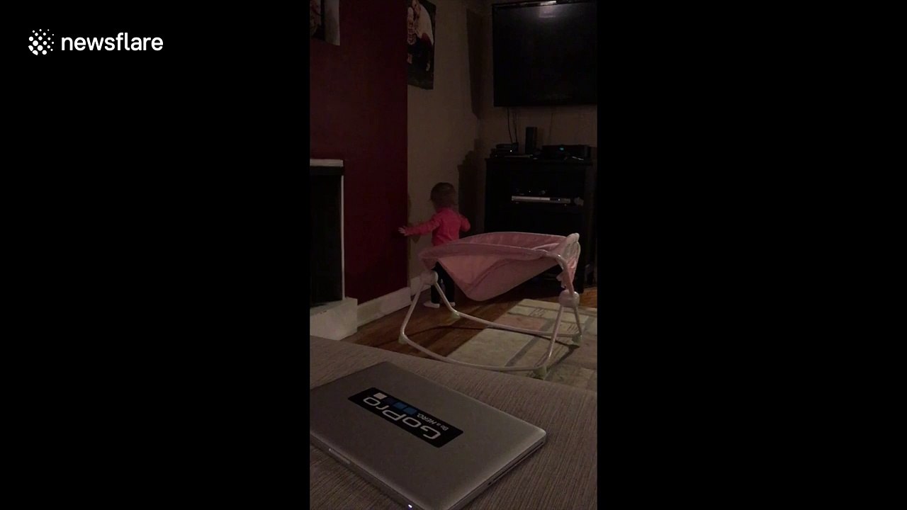 Baby plays hide and seek with her shadow