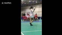 Woman performs keepie uppie tricks with shuttlecock