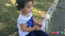 Toddler learning ABC Alphabets on a White Flags _ Fun outdoors park-n