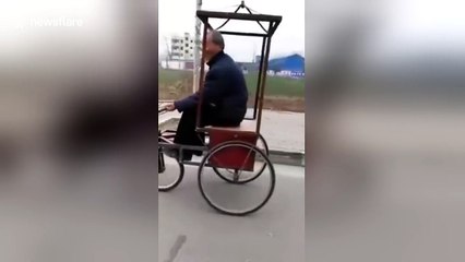 Man uses dog to pull his homemade tricycle