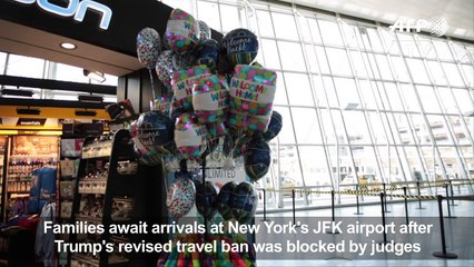 Families await arrivals at JFK airport after travel ban blocked