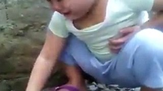 Little girl crying over dead chicken 