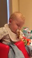 Tired baby falls asleep at dinner table