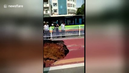 Bus causes deep sinkhole to open on road in China