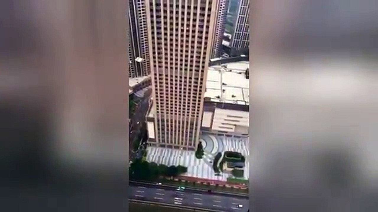 AMAZING Man BASE jumps from the top of a skyscraper in China