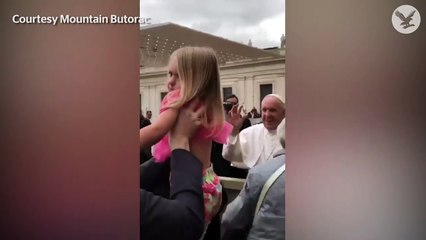 Little girl steals the Pope's hat.