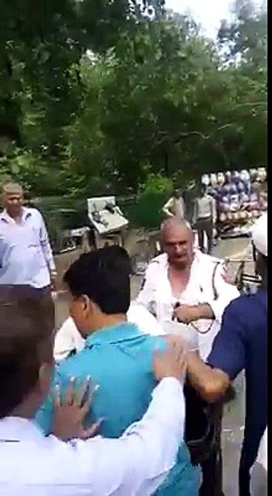 People Beating a Police man in Public Place