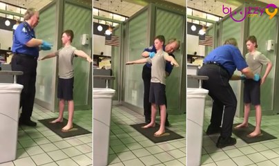 Contrôlé à l'aéroport, un enfant se fait fouiller de près par un agent de sûreté.