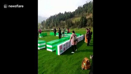 Chinese people play giant mahjong in tourist attraction