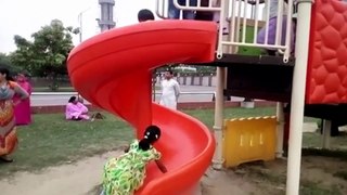 Slide for kids playing park with her parents indoor and outdoor.
